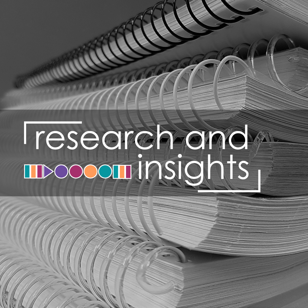 A picture of a stack of notebooks, text overlay reads "research and insights"